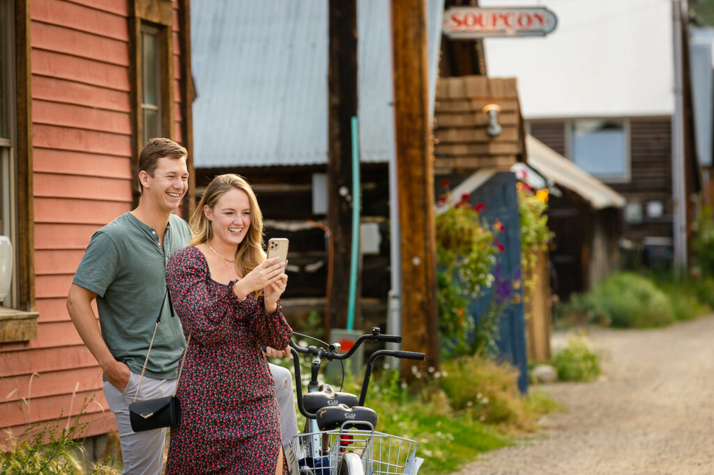 on phone in alley Crested Butte photographer Gunnison photographers Colorado photography - proposal engagement elopement wedding venue - photo by Mountain Magic Media