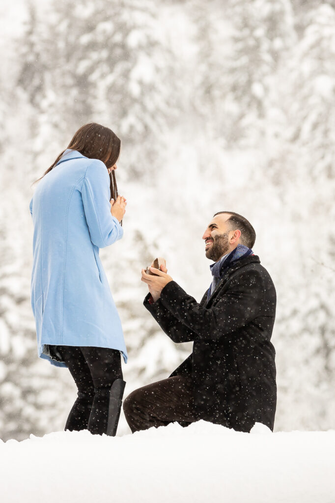 Aspen Carriage and Sleigh snowy Aspen, CO surprise proposal sleigh ride winter blue coat on one knee with engagement diamond ring Crested Butte photographer Gunnison photographers Colorado photography - proposal engagement elopement wedding venue - photo by Mountain Magic Media