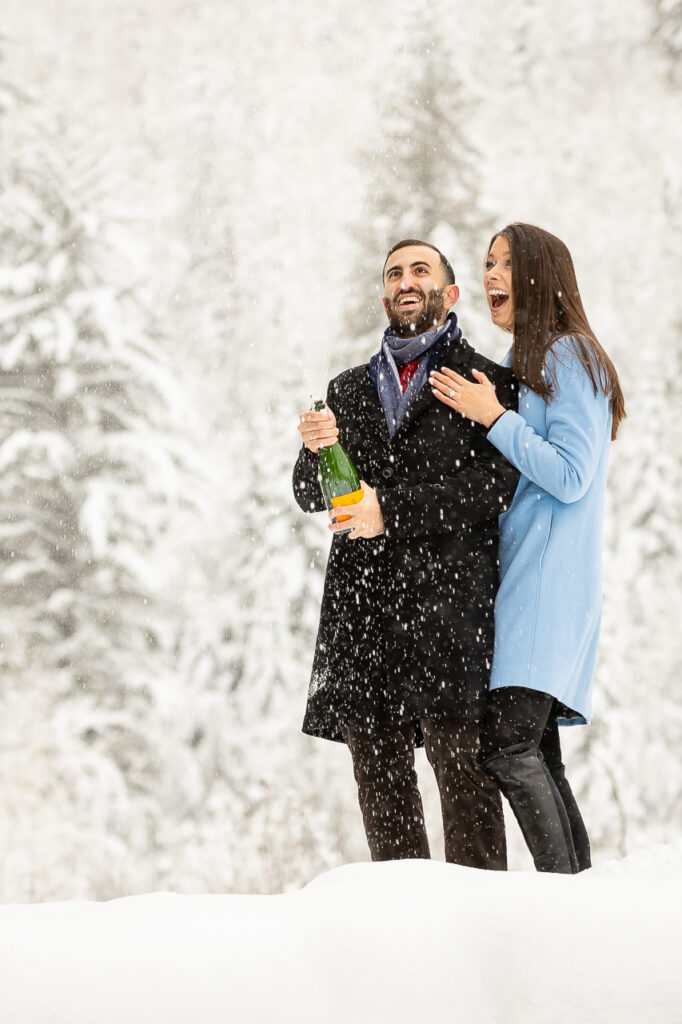 popping champagne celebration Aspen winter surprise sleigh ride proposals snowy scene snow storm Crested Butte photographer Gunnison photographers Colorado photography - proposal engagement elopement wedding venue - photo by Mountain Magic Media