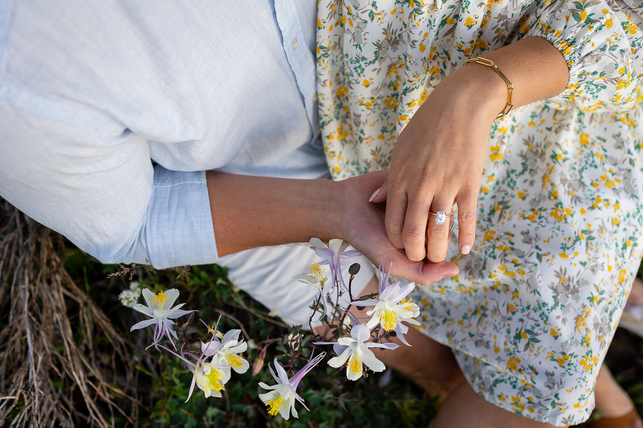custom engagement ring diamond holding hand columbines wildflowers Crested Butte photographer Gunnison photographers Colorado photography - proposal engagement elopement wedding venue - photo by Mountain Magic Media