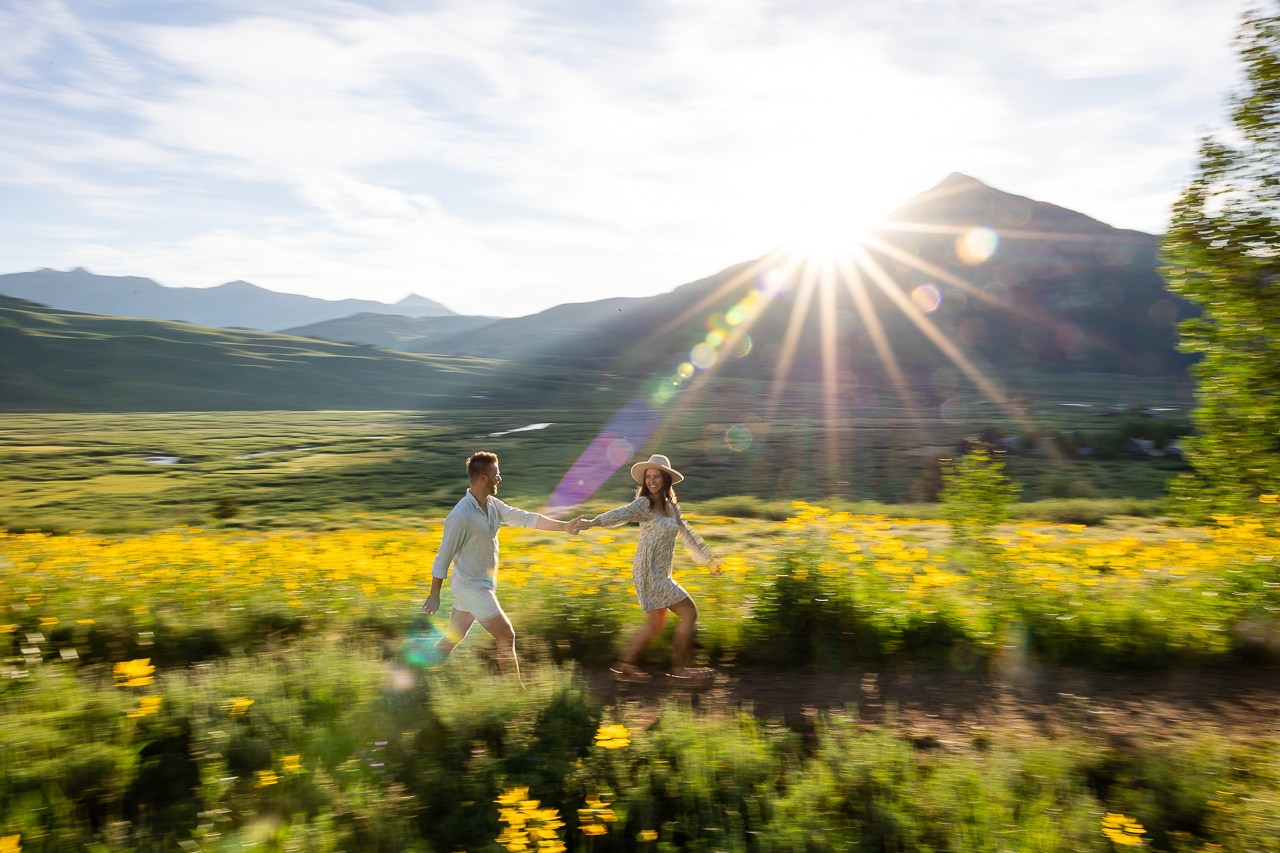 sunrise Woods Walk sun flare couple running engaged Crested Butte photographer Gunnison photographers Colorado photography - proposal engagement elopement wedding venue - photo by Mountain Magic Media