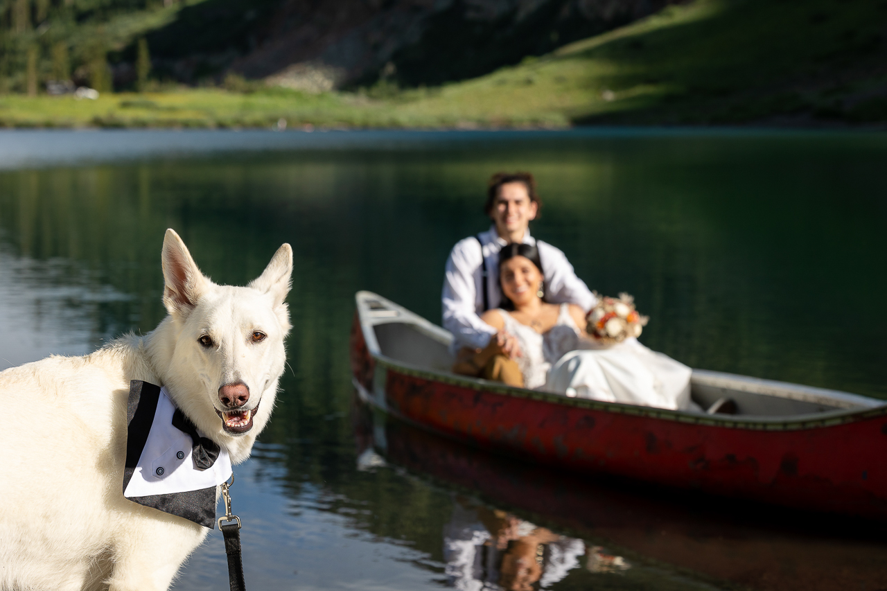 Emerald Lake canoe dog friendly newlyweds in boat on water pup wearing tuxedo bandana Crested Butte photographer Gunnison photographers Colorado photography - proposal engagement elopement wedding venue - photo by Mountain Magic Media