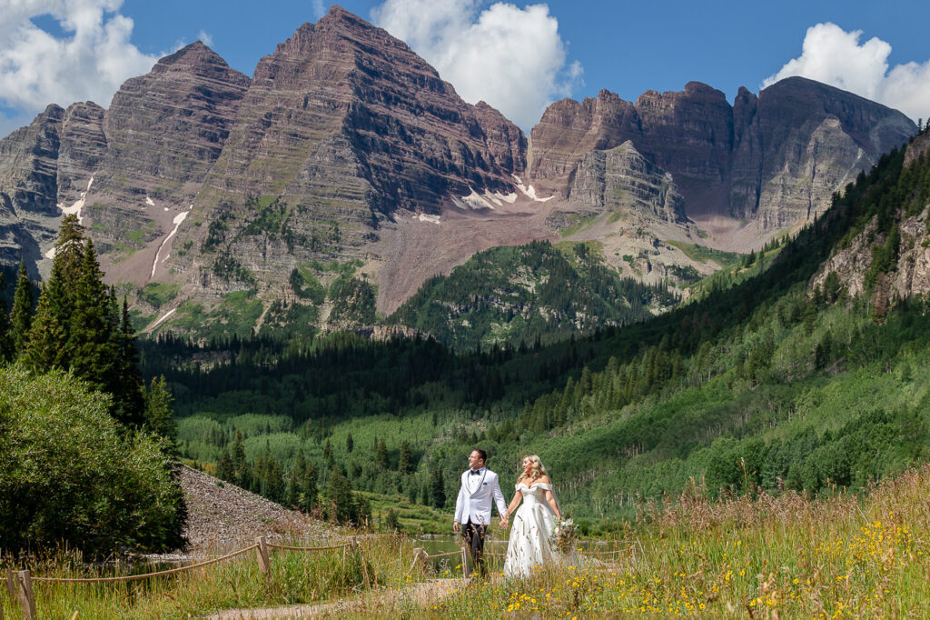 Aspen Maroon Bells view adventure instead vow of the wild outlovers vows newlyweds couple walking hand in hand Crested Butte photographer Gunnison photographers Colorado photography - proposal engagement elopement wedding venue - photo by Mountain Magic Media