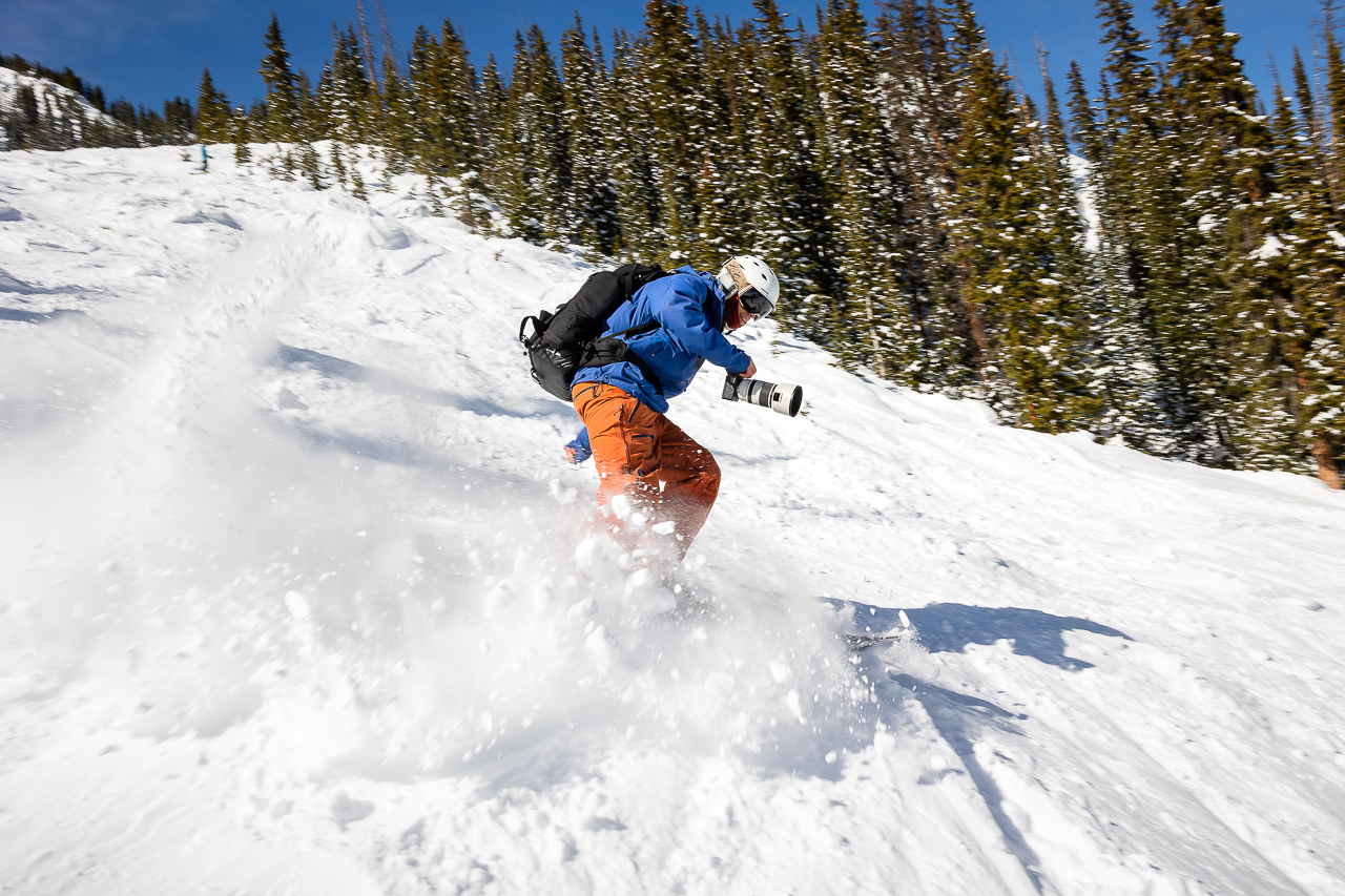 holding camera while skiing on mountain photoshoot Crested Butte photographer Gunnison photographers Colorado photography - proposal engagement elopement wedding venue - photo by Mountain Magic Media