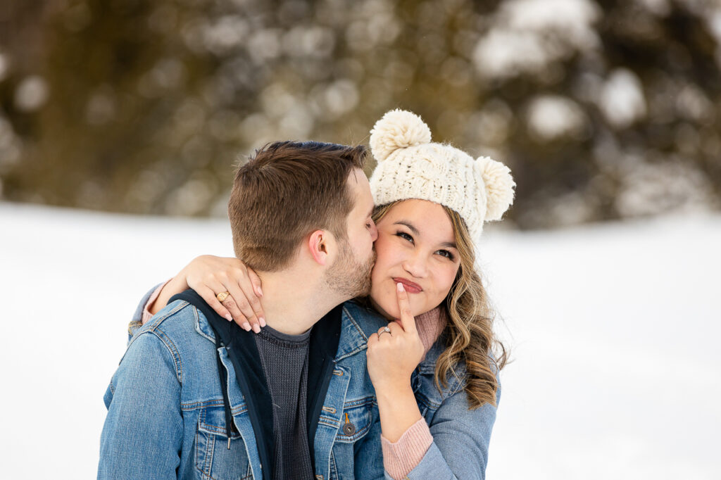 cute hat with ears and finger on mouth pensive thinking hmm wondering what to wear jean jackets cute couple Crested Butte photographer Gunnison photographers Colorado photography - proposal engagement elopement wedding venue - photo by Mountain Magic Media