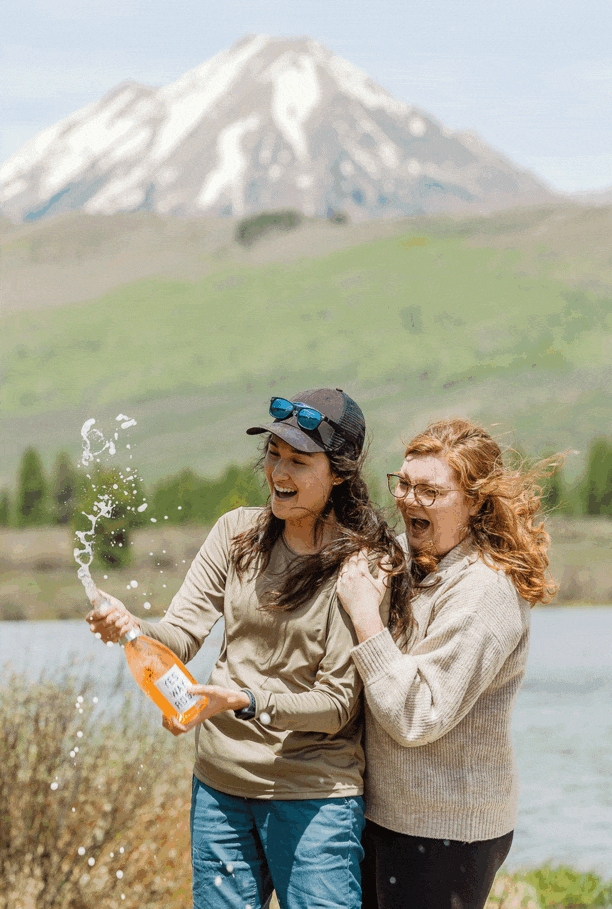 spraying champagne with a Colorado proposal photographer