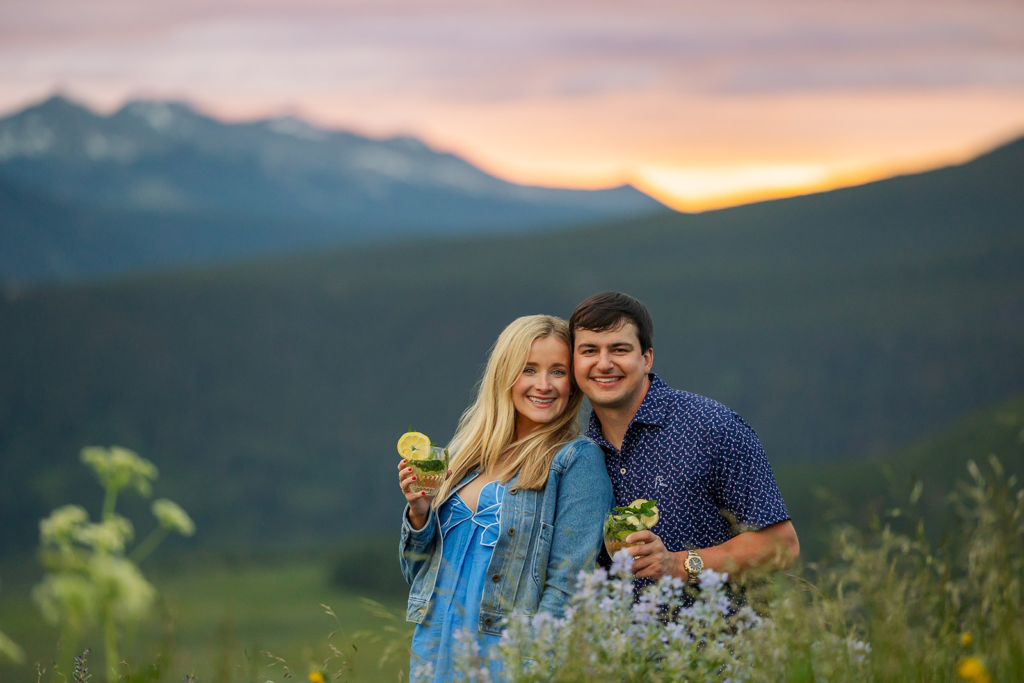 Couple celebrating proposal near Crested Butte Colorado at sunset with Hugo Spritz drinks