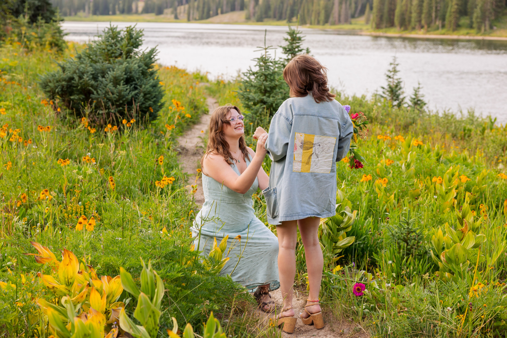 woman proposing to woman in Crested Butte with summer mountain lake views Proposal Packages